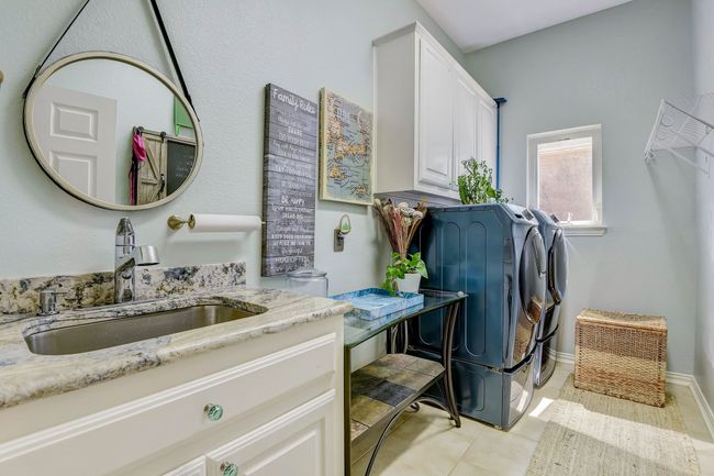 Spacious utility room with cabinets, sink with azurite granite countertops | Image 27