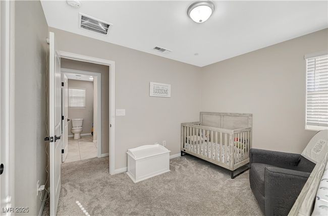 Carpeted bedroom featuring multiple windows and baseboards | Image 47