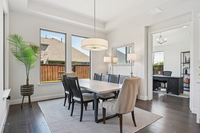 Dining room featuring plenty of natural light, dark wood-style floors, and a raised ceiling | Image 11