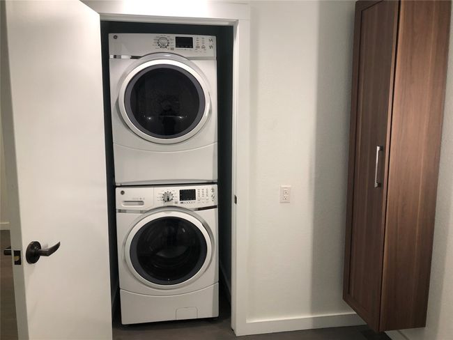 Laundry area featuring stacked washer and clothes dryer | Image 10