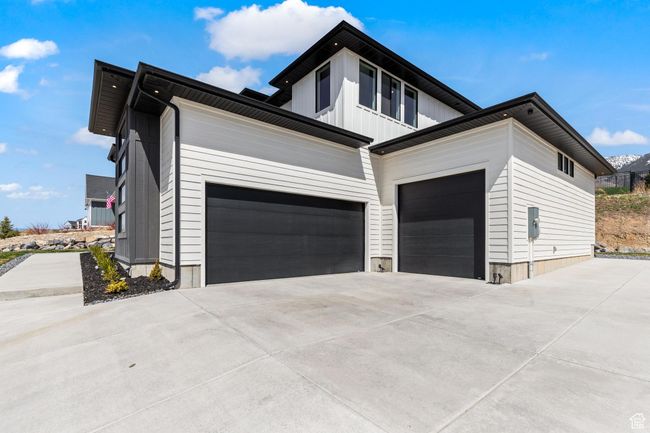 View of home's exterior with driveway and an attached garage | Image 7
