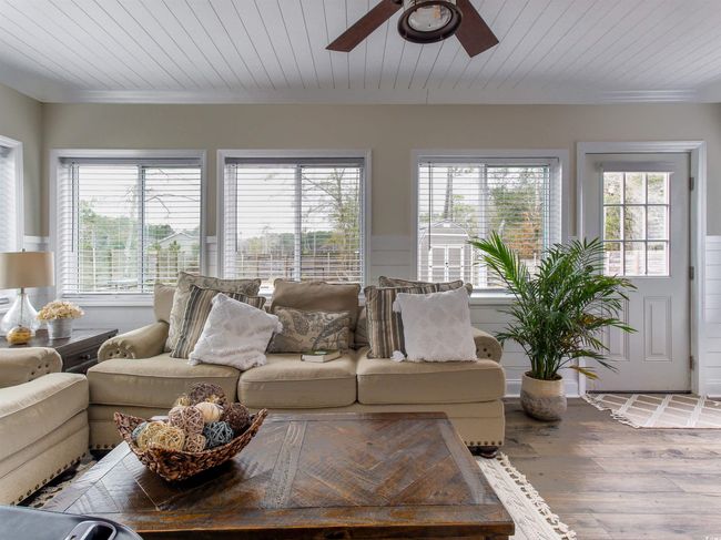 Living room with hardwood / wood-style flooring, a wealth of natural light, and wood ceiling | Image 16