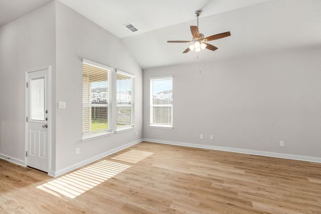 Empty room featuring light wood-type flooring, visible vents, lofted ceiling, and baseboards | Image 16