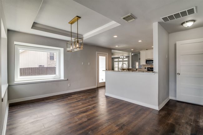 Kitchen view from second living area. The door to the right leads to the laundry room. | Image 8
