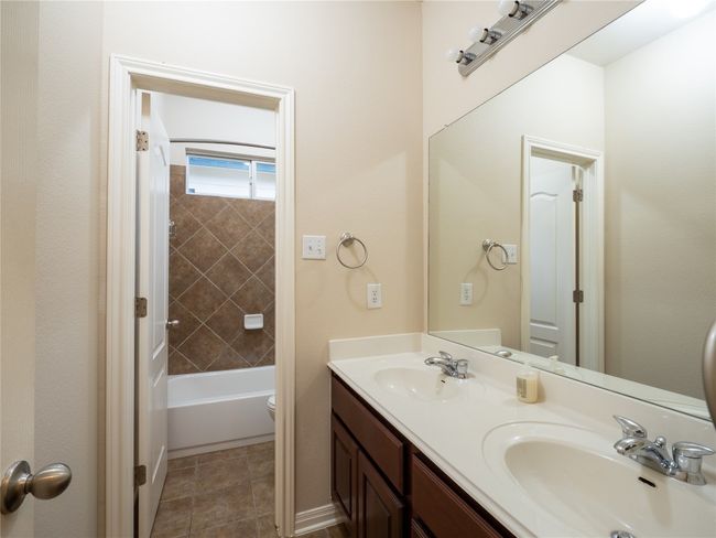 Full bathroom #2 with double vanity, and separate toilet, and shower combination. | Image 21
