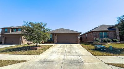 View of front facade with a front lawn and a garage | Image 2