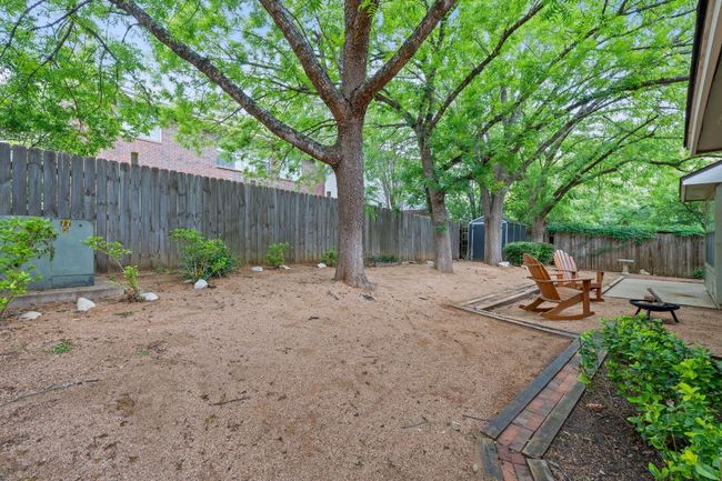 This spacious fenced-in yard offers plenty of space for play, gardening, BBQing, and more. | Image 32