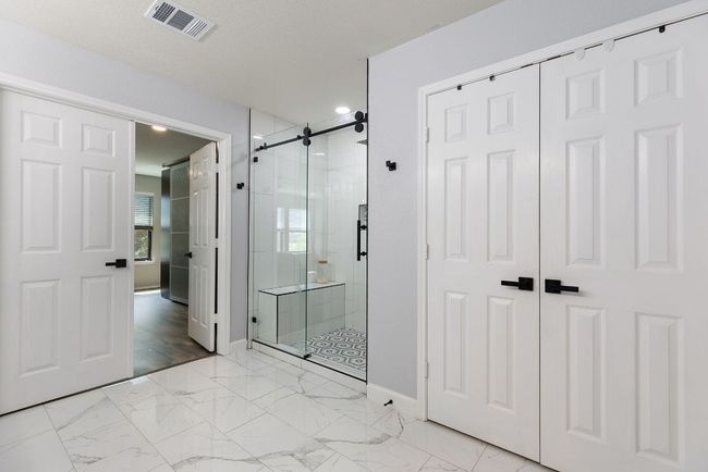 Full bath featuring a shower stall, baseboards, recessed lighting, and marble finish floors | Image 25