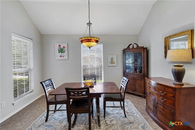 Formal dining off entry with high ceiling, custom lighting, tile flooring | Image 16