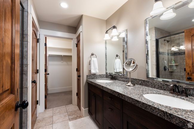 Bathroom with visible vents, a sink, a spacious closet, and a shower stall | Image 18