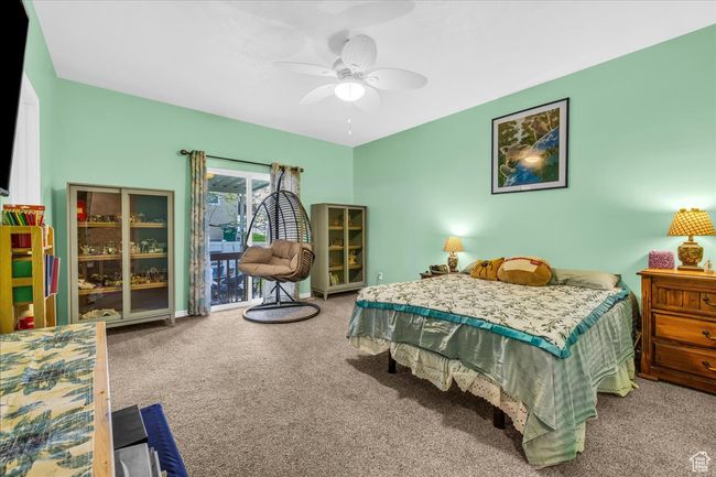 Bedroom featuring ceiling fan and carpet floors | Image 19
