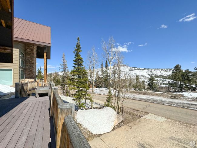 Snow covered deck with a mountain view | Image 50