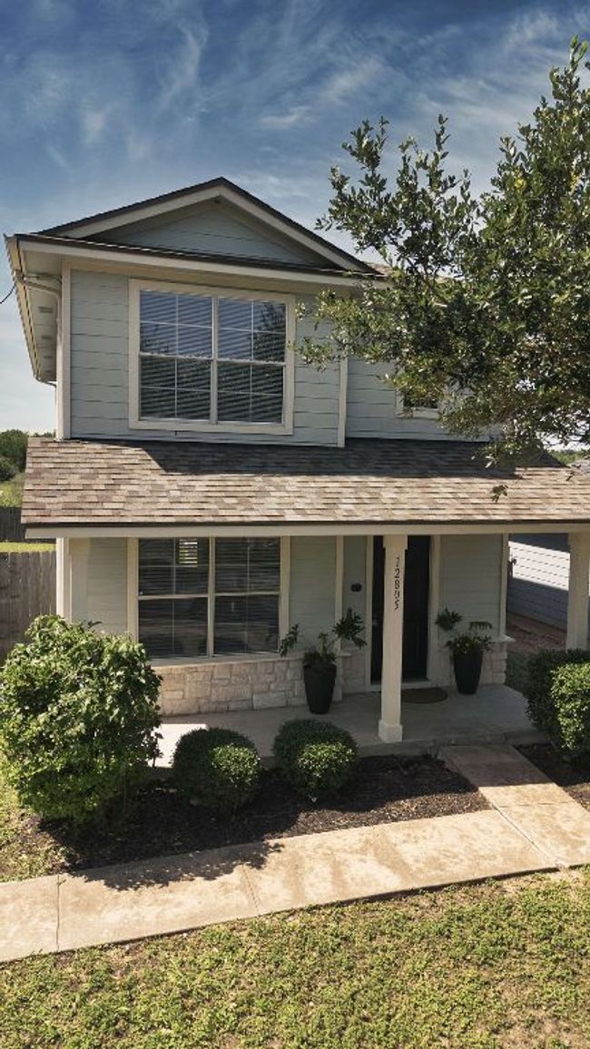View of front of house with a porch, roof with shingles, and stone siding | Image 5