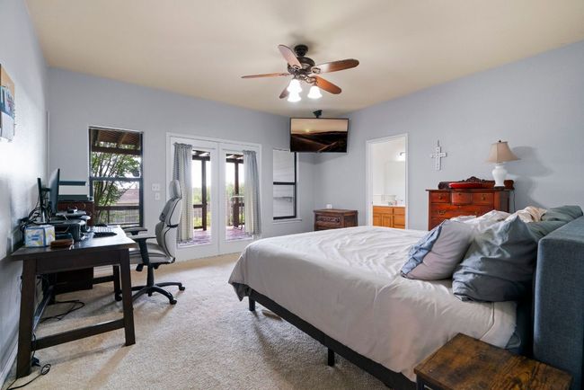 Double doors, double windows, and a whole lot of calm—wake up to backyard views and easy Hill Country breezes. | Image 7