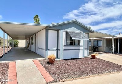 EXTERIOR VIEW OF HOME WITH LARGE COVERED PATIO | Image 1