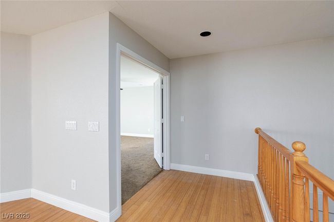 Corridor featuring light wood finished floors, baseboards, and an upstairs landing | Image 24