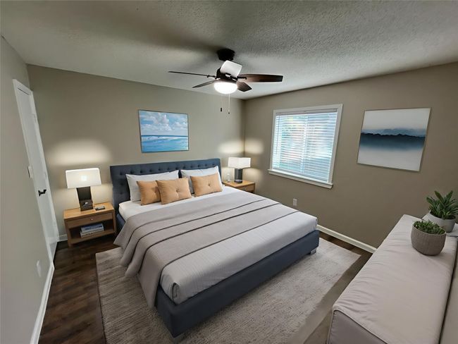 Bedroom with wood finished floors, a ceiling fan, and a textured ceiling | Image 12