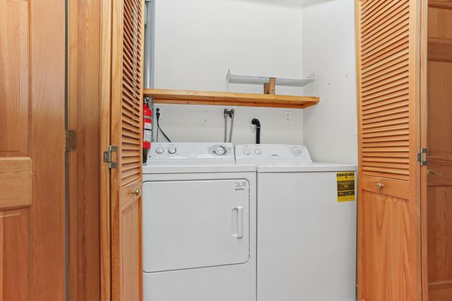 Laundry area featuring washer and clothes dryer | Image 26