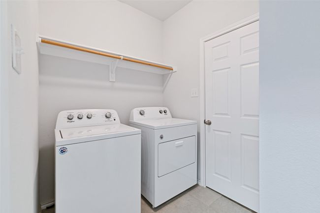 Washroom with separate washer and dryer and light tile patterned flooring | Image 19
