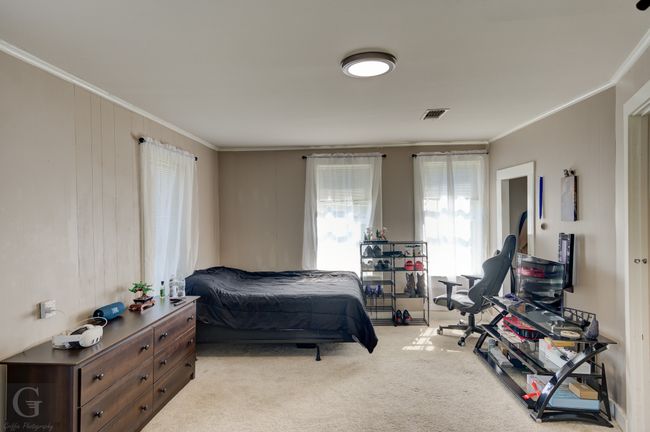 Bedroom with crown molding and light carpet | Image 22