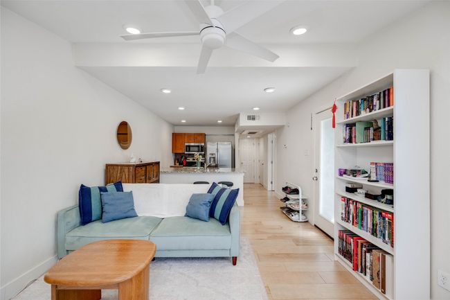Living room with ceiling fan, light wood finished floors, and recessed lighting | Image 5
