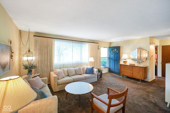 living area with dark colored carpet | Image 10