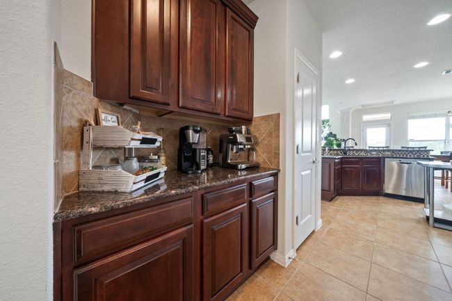 Kitchen with dishwasher, tasteful backsplash, recessed lighting, light tile patterned floors, and dark stone counters | Image 8
