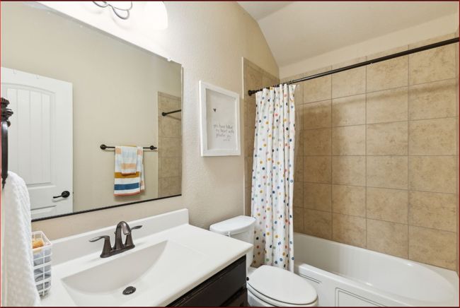 Full bath with vanity, shower / tub combo, and lofted ceiling | Image 20