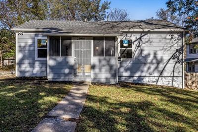 View of front of home featuring a front yard and a sunroom | Image 1