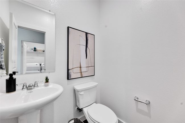 Bathroom with a sink and toilet | Image 25