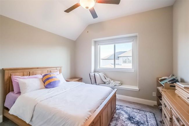 Upstairs secondary bedroom with ceiling fan and little window seat. | Image 28