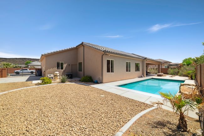 View of swimming pool featuring a gate, a fenced in pool, a patio area, and a fenced backyard | Image 31