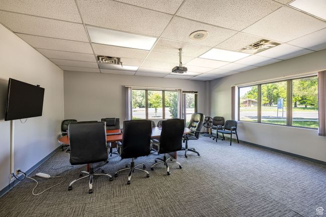 Carpeted office with a paneled ceiling and healthy amount of natural light | Image 11