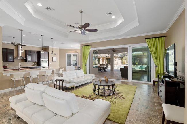 Open floor plan with view of kitchen and also easy access to pool area | Image 32