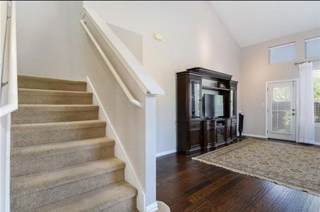Entrance foyer featuring high vaulted ceiling and dark hardwood / wood-style flooring | Image 4