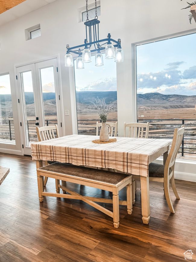 Dining area with dark wood-type flooring, a mountain view, and baseboards | Image 14