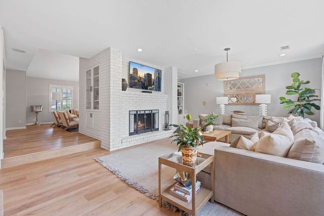 Bright and airy second living area perfect for family gathings. Also features wood burning fireplace. | Image 6