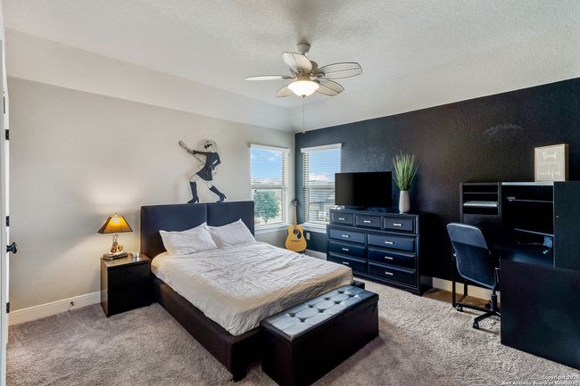 A warm and carpeted spacious bedroom. | Image 42
