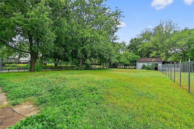 View of yard featuring view of wooded area | Image 21