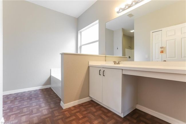 Bathroom featuring vanity and a garden tub | Image 10