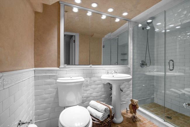 Full bath with recessed lighting, a stall shower, wainscoting, tile walls, and a sink | Image 21