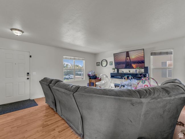 Living room featuring light wood finished floors and baseboards | Image 4