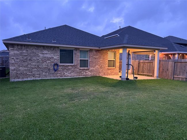 Expansive backyard with excellent lighting, perfect for enjoying beautiful Texas evenings. | Image 20