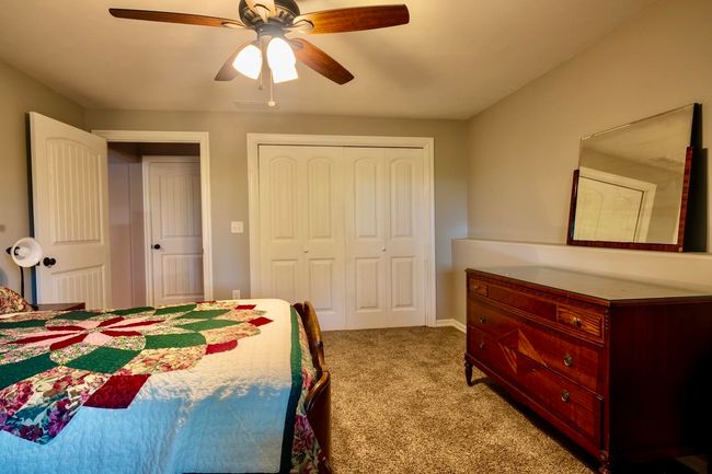Bedroom with carpet floors, a ceiling fan, and a closet | Image 29