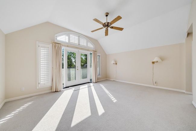 Unfurnished living room featuring ceiling fan, vaulted ceiling, carpet floors, and baseboards | Image 20