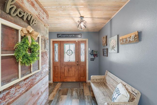 Spacious open entry featuring a custom-designed Texas door | Image 41