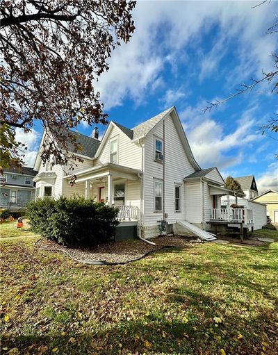 Front and side of property featuring porches and lawn | Image 2