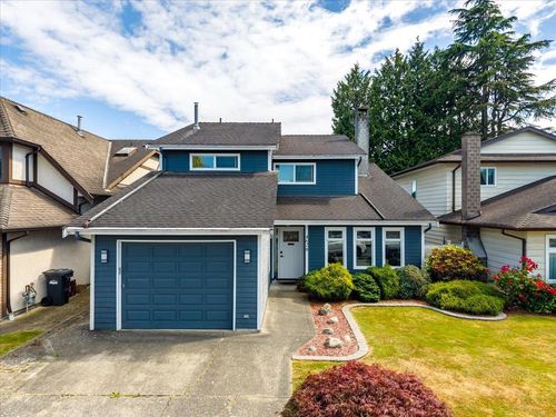 Blue exterior with white trim, featuring a single-car garage and a concrete driveway | Card Image
