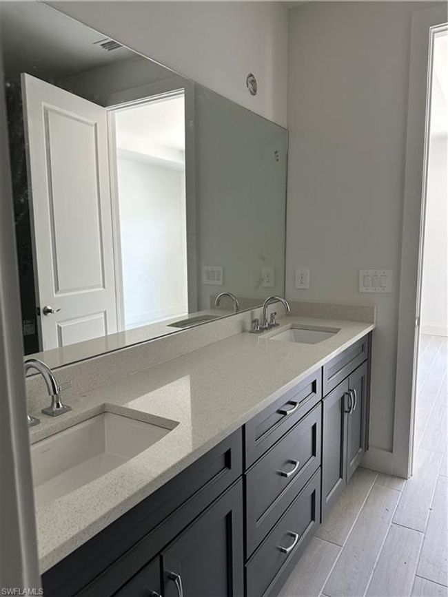 Bathroom featuring double sink vanity and hardwood / wood-style floors | Image 15