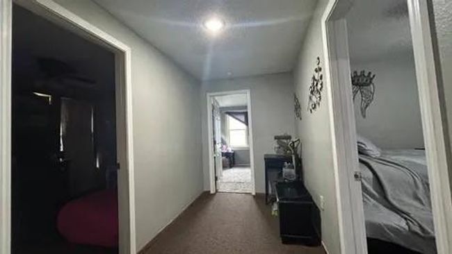 Corridor featuring dark colored carpet | Image 23
